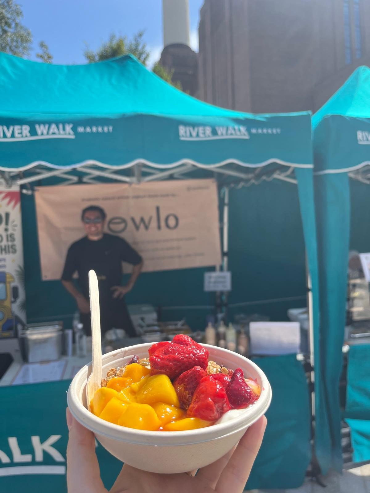 A bowl topped with fresh mango and berries