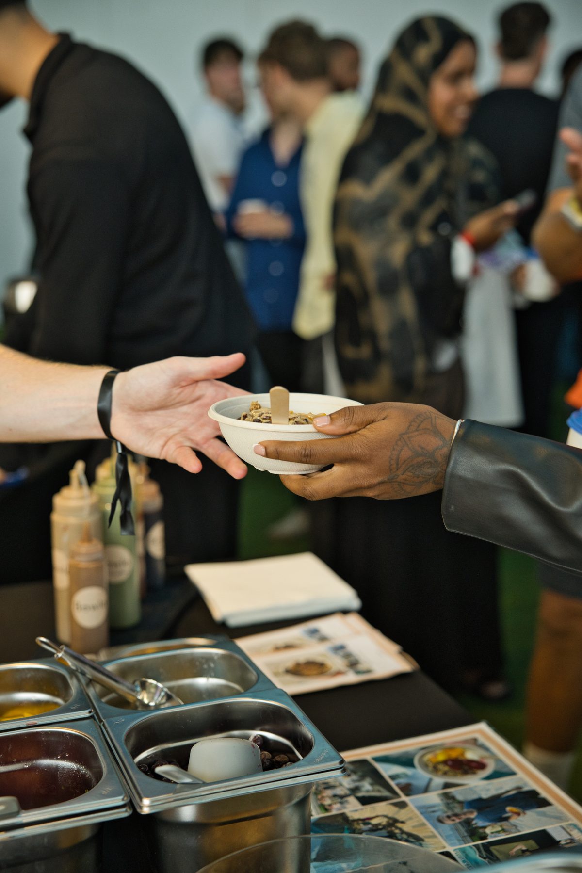 Handing a finished bowl across the counter