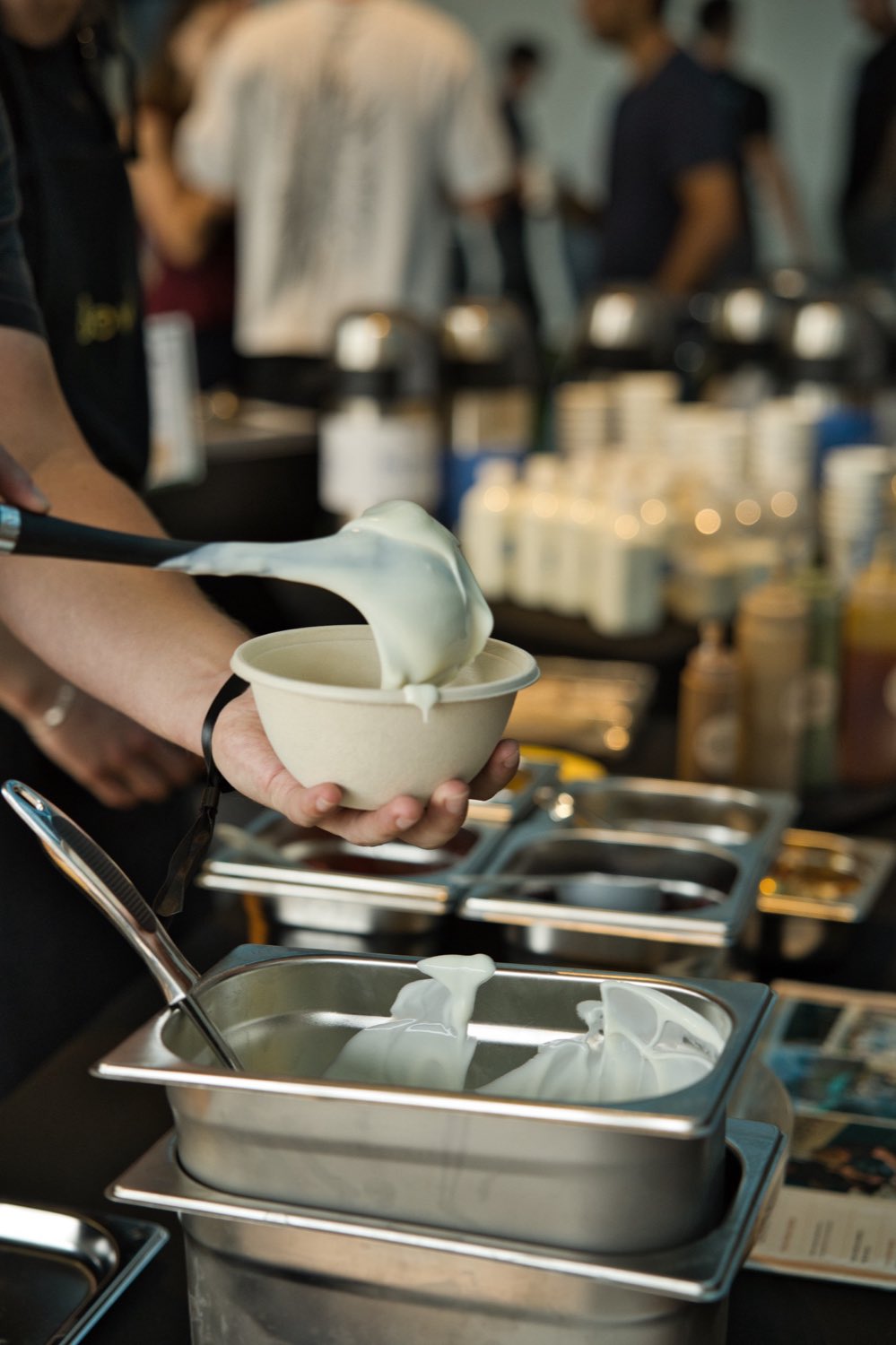 Yoghurt being spooned into a bowl at the stall